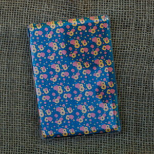 Back of kindle paperwhite with pumpkins and petals pattern insert on a burlap background