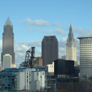 The skyline of Cleveland including terminal tower and the key bank building as well as the drawbridge at the flats.