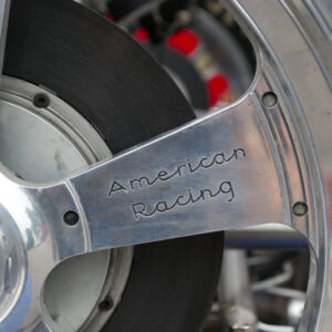 Close up of the hubcap on a racing tire with the inscription "American Racing"
